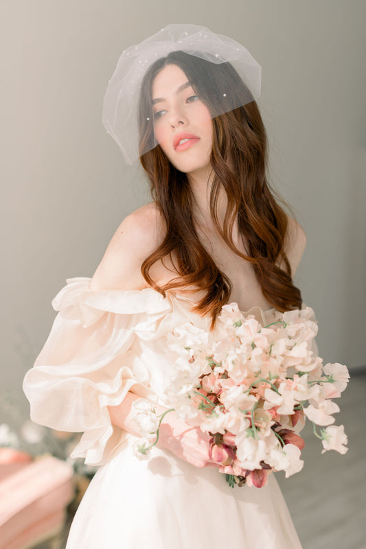 What are some styling tips for wearing a birdcage veil?