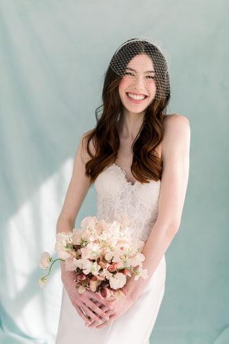 How do I choose the right birdcage veil for my wedding look?