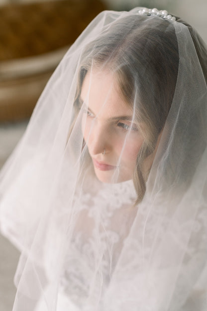 Woman wearing a white veil with a blurred background