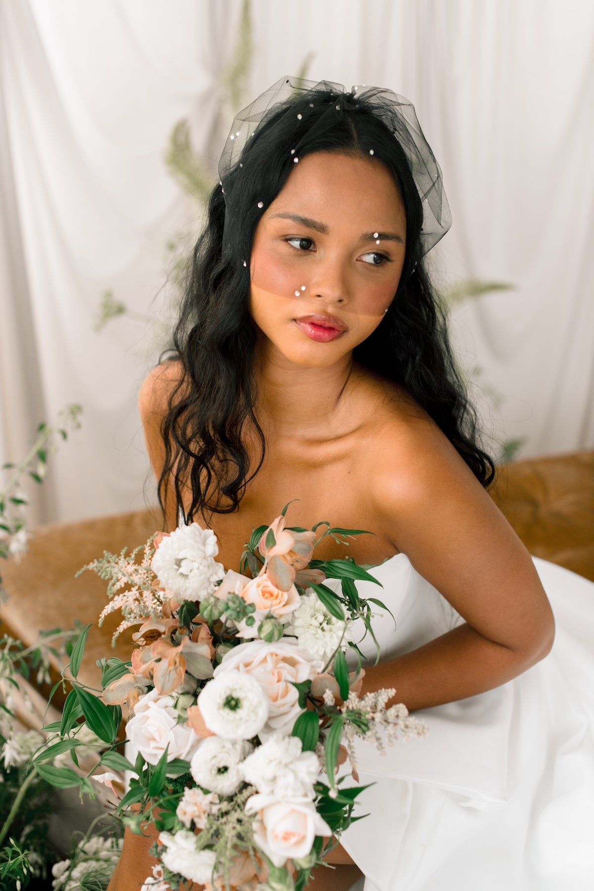 Bride holding a bouquet with a neutral background